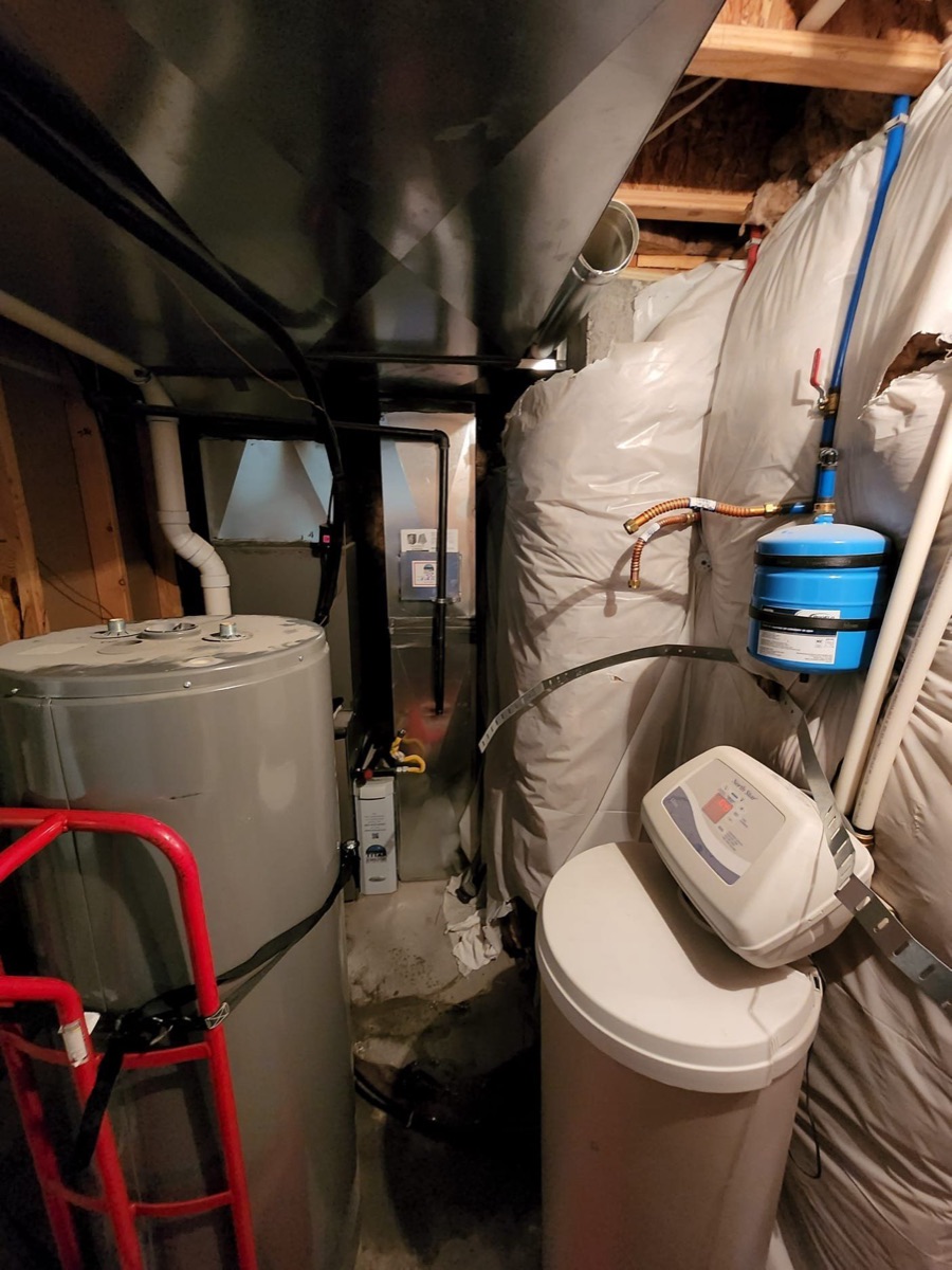 Basement utility area with water heater, furnace and filtration tank (site alt text)