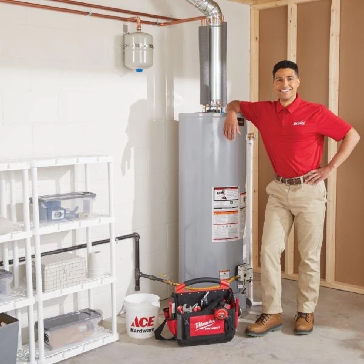 Ace Hardware Home Services plumber next to a newly installed water heater
