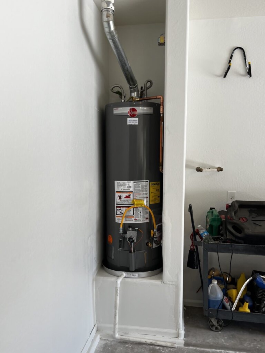 Newly installed Rheem gas tank water heater in a garage alcove