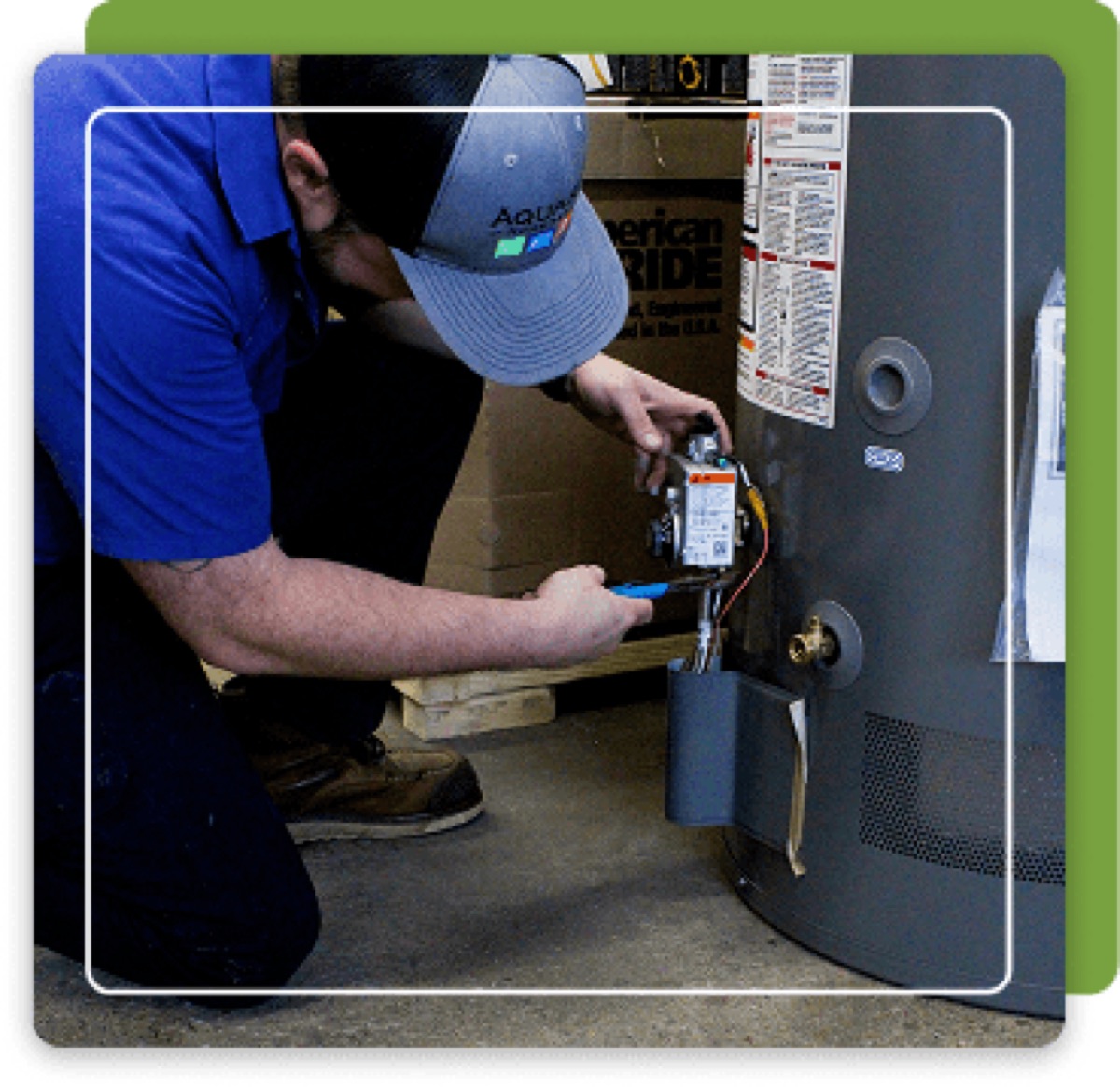 Aquarius technician in branded cap working on a tank water heater's gas valve