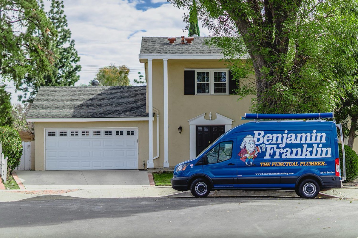 Benjamin Franklin service van parked outside a home