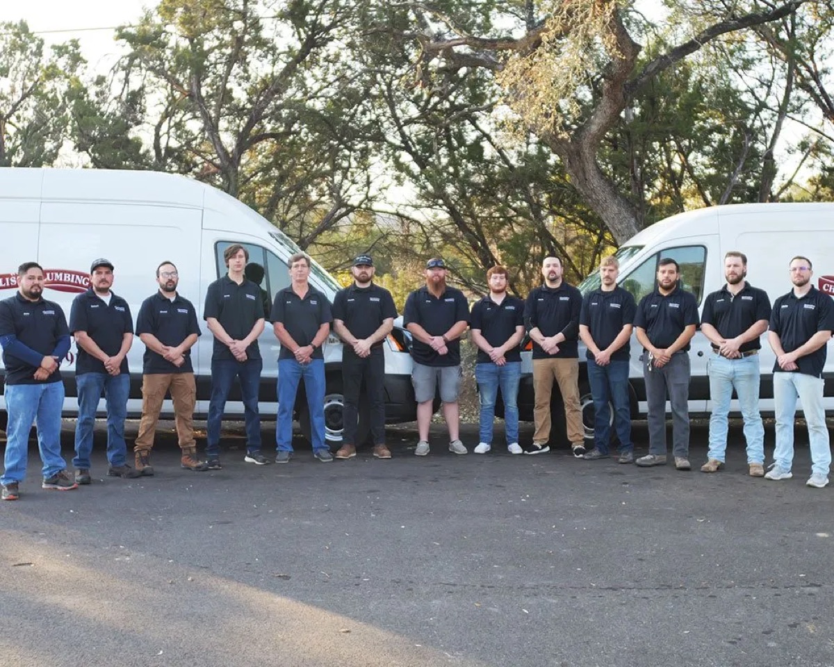 Chambliss plumbers lined up outside next to their company vans