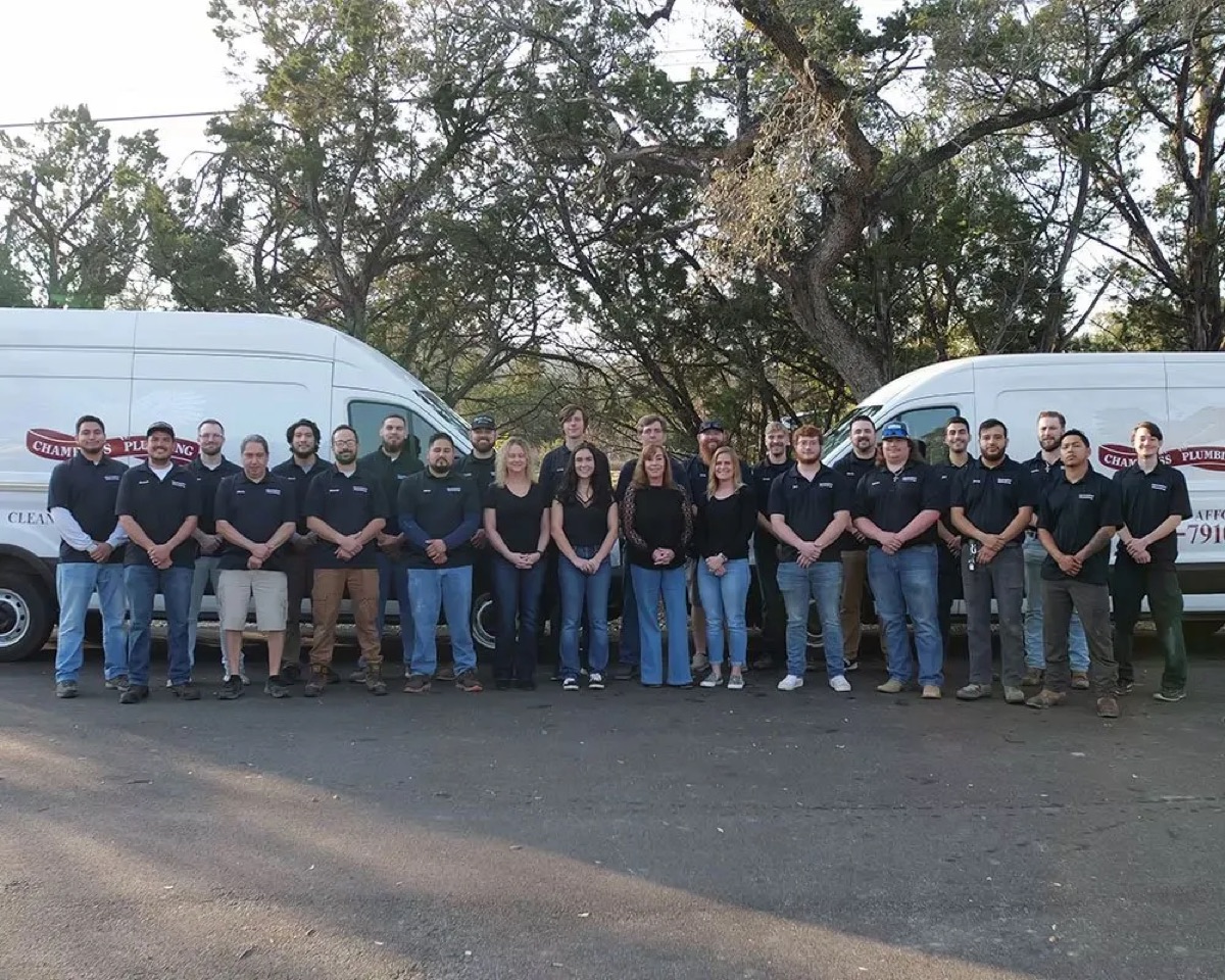 Full Chambliss team photo in front of company vans