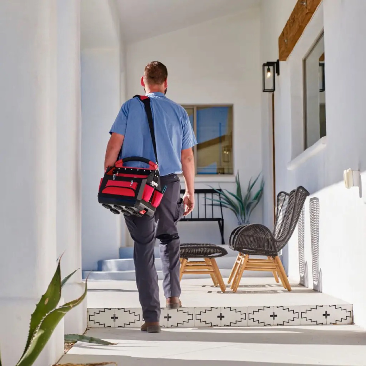 Technician installing a water heater (filename 'Water-Heater-Installation-Worker')
