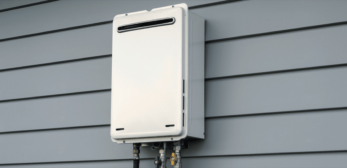 Tankless water heater mounted on exterior siding