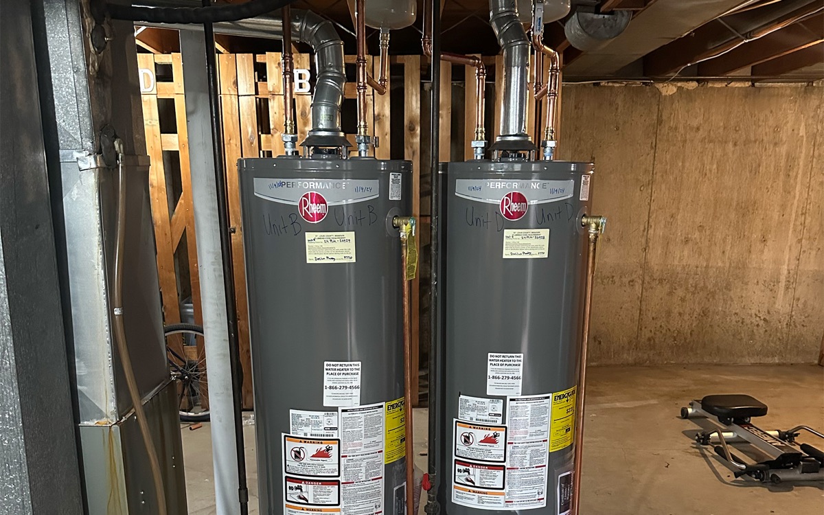 Two Rheem gas tank water heaters installed side by side in a basement (projects page)