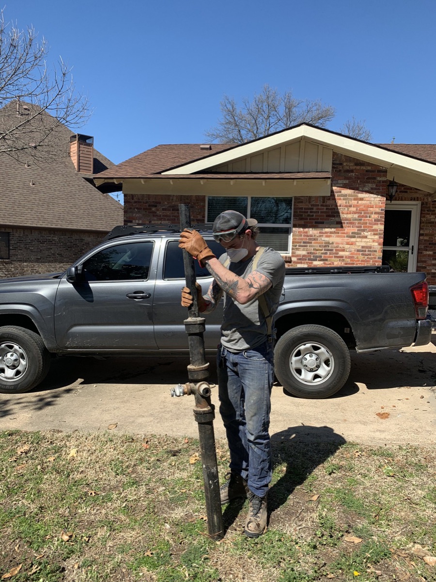 Plumber with work truck on a residential service call