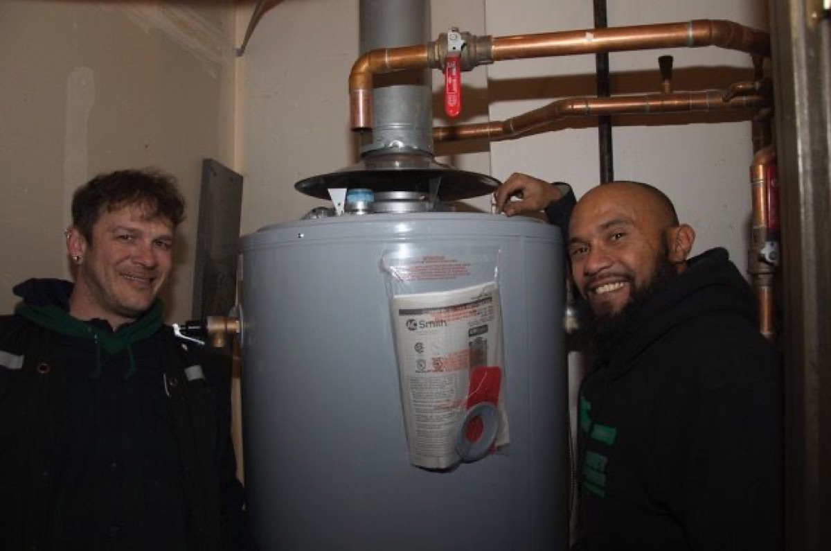 Green Planet plumbers with a newly installed tank water heater