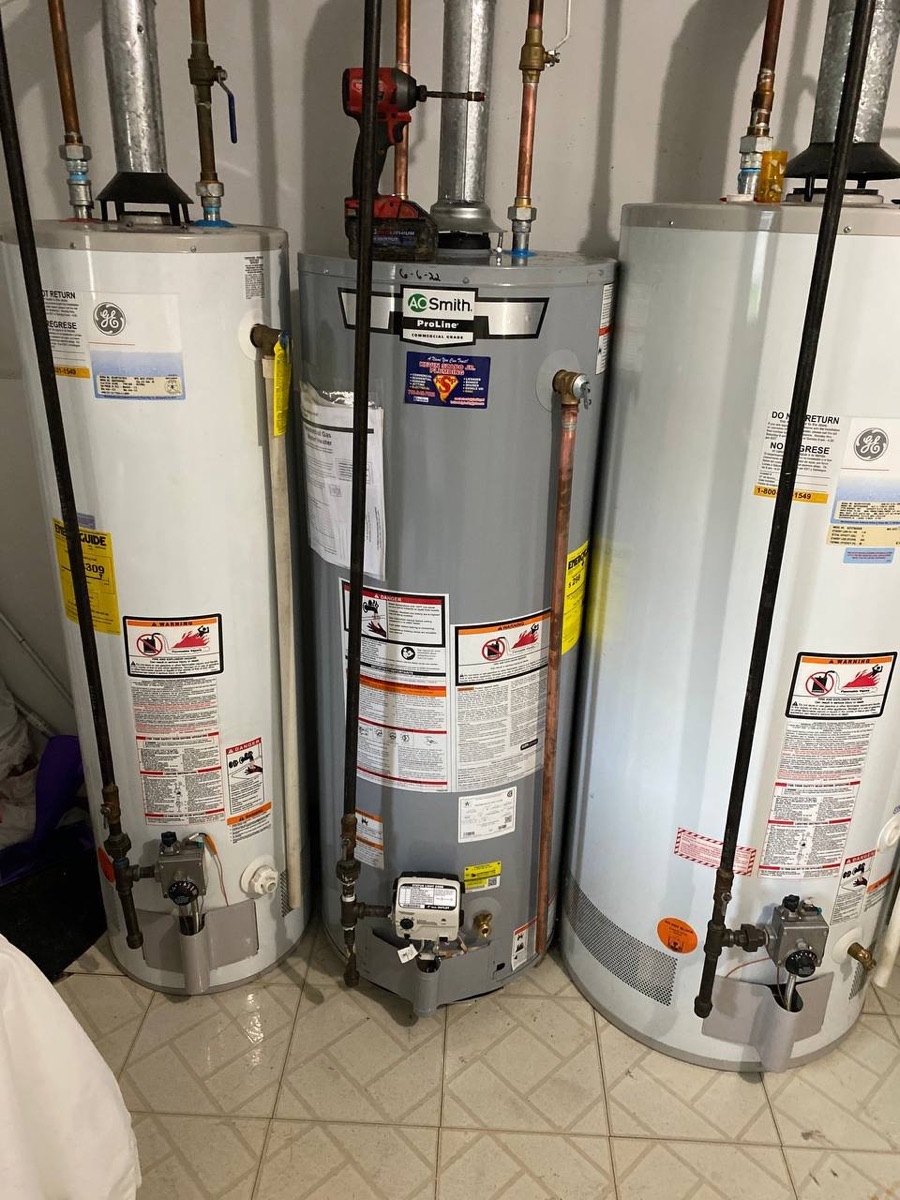 Row of three tank water heaters installed side by side