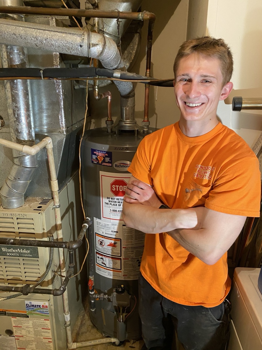 Plumber Logan Walker installs water heaters in Orland Park (site caption)