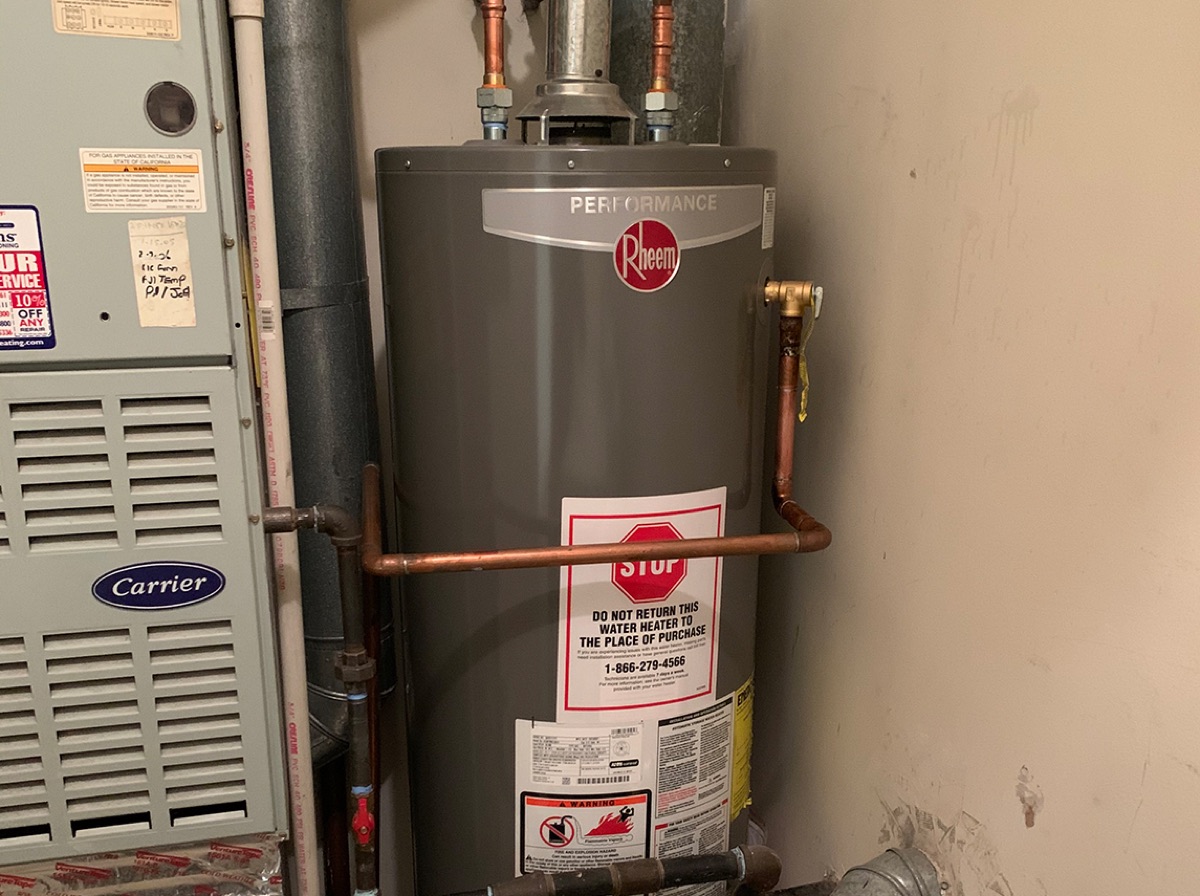 Rheem Performance gas tank water heater installed beside a furnace (company portfolio, 'water heater installations')