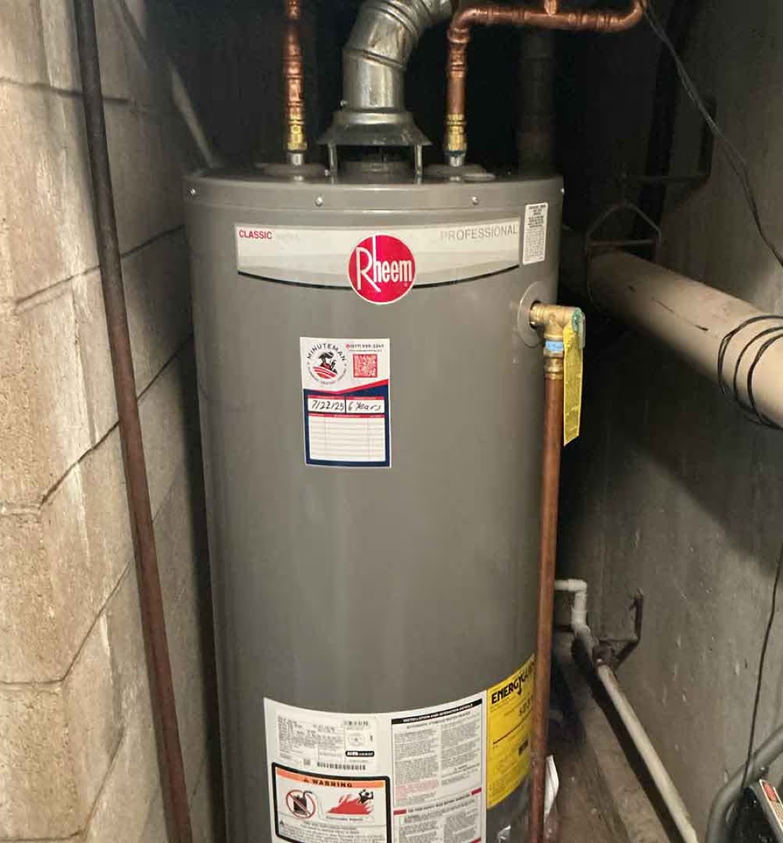 Rheem water heater installed by Minuteman Plumbing with copper piping (per site alt text)