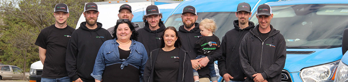 Modern Plumbing & Heating team group photo in front of vans