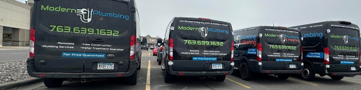 Row of Modern Plumbing & Heating branded service vans