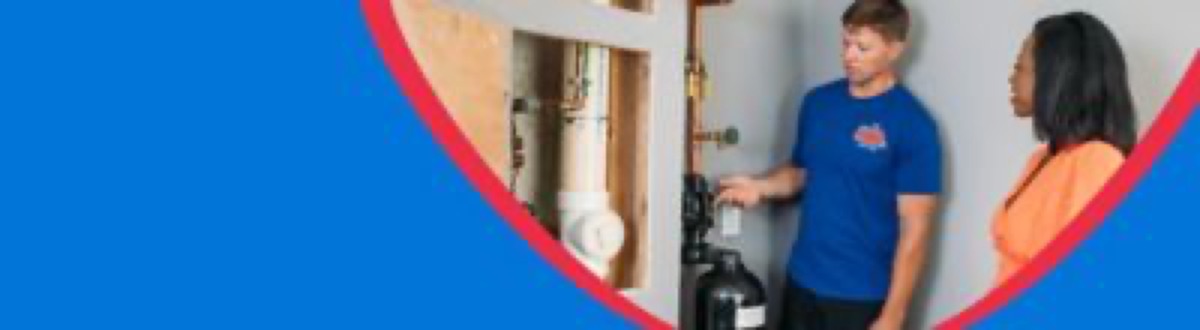 Mr. Plumber technician looking at a water heater with a customer