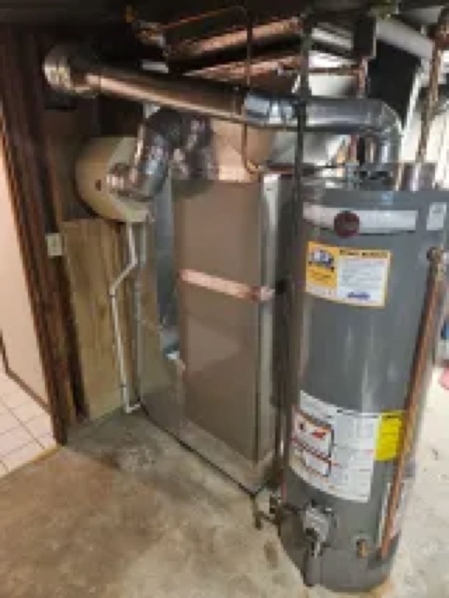 Gas tank water heater installed beside a new furnace (site project 'Carrier Furnace, Central AC and Water Heater Installation', photo 2 of 3)