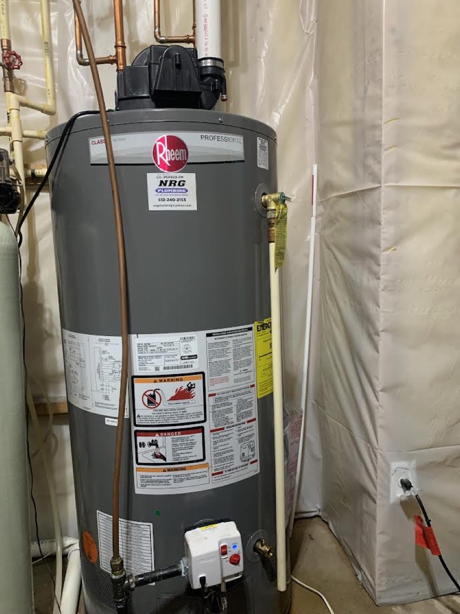 Tall gray Rheem gas tank water heater installed in a basement utility area