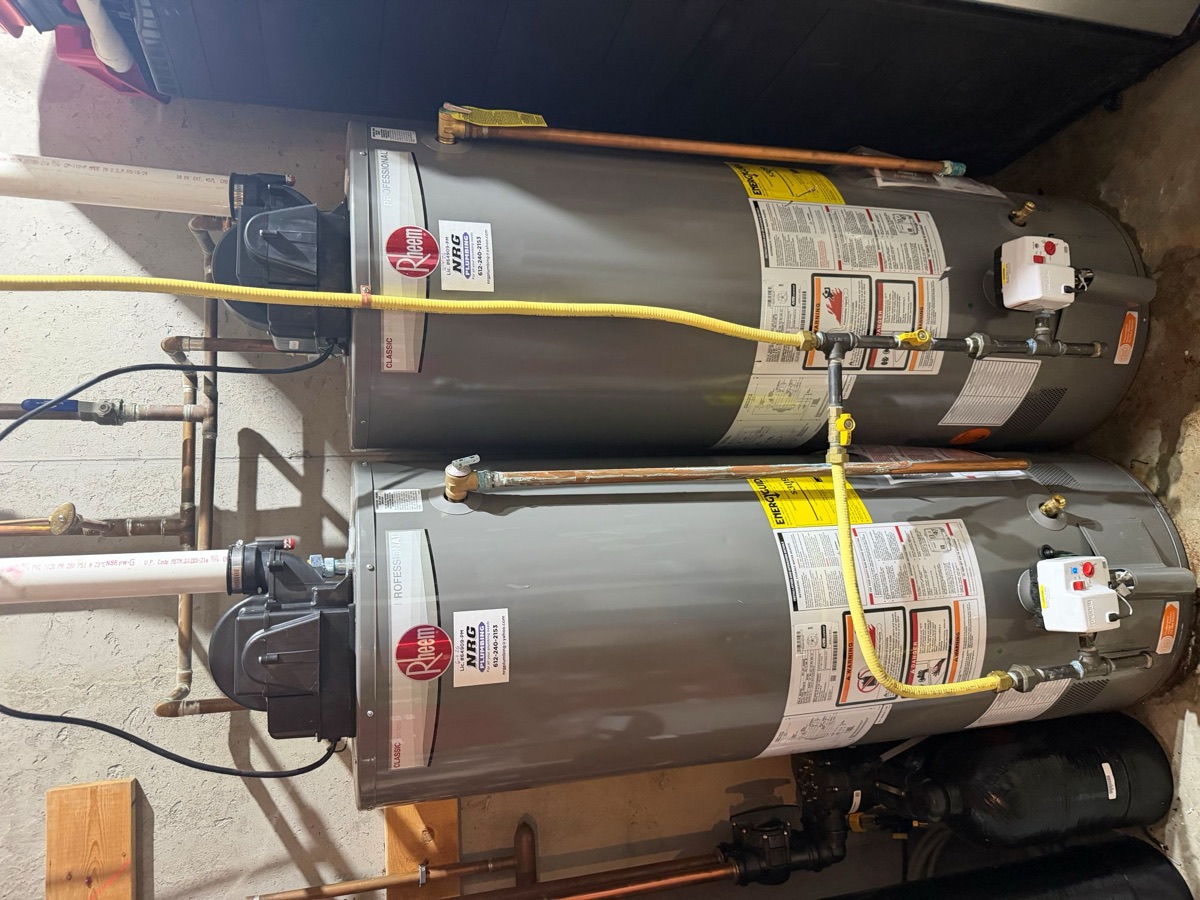 Two tank water heaters installed side by side, viewed from above