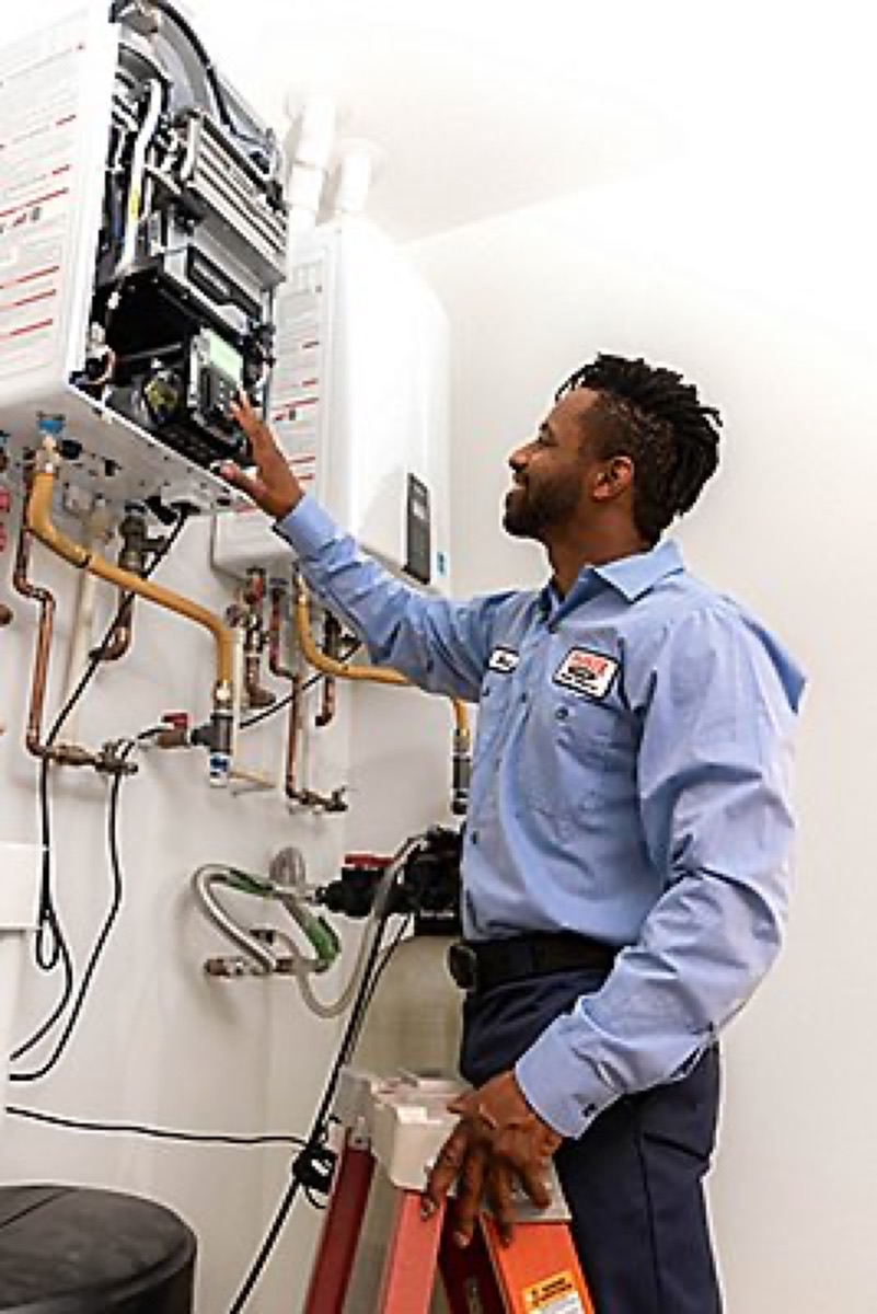 Technician checking a tankless water heater