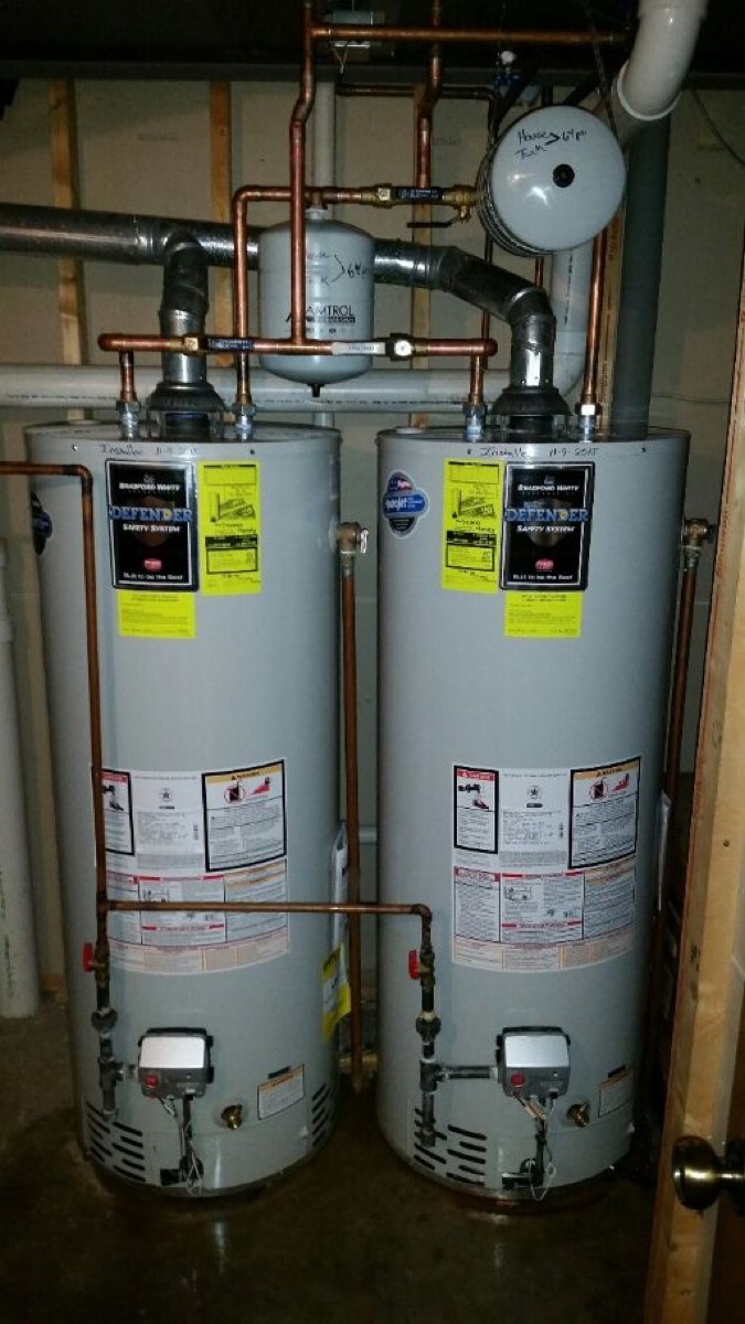 Two gas tank water heaters installed side by side with expansion tank (gallery file name references 63141)