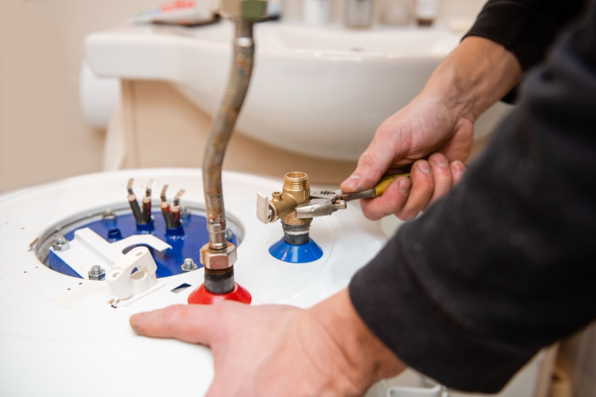 Reliable technician installing a water heater