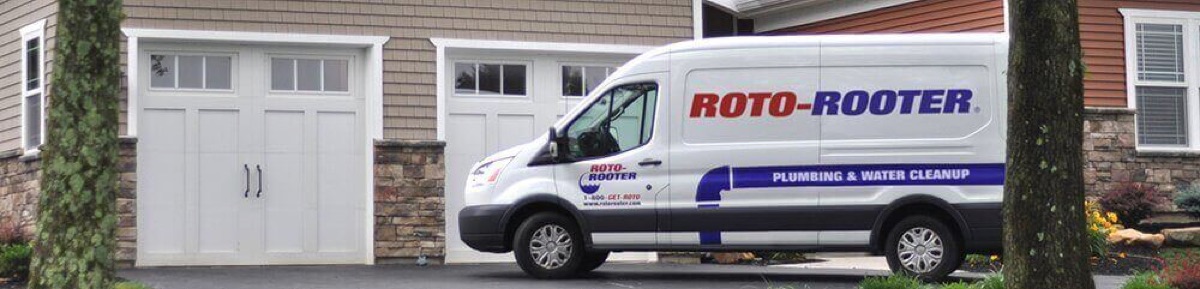 Roto-Rooter service van parked in a home driveway