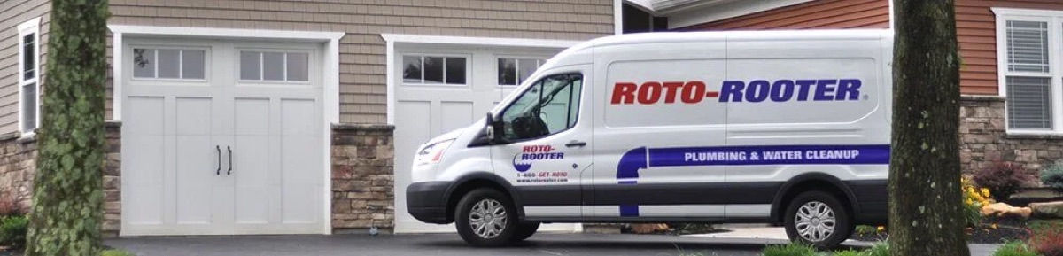 Roto-Rooter service van parked in a home driveway