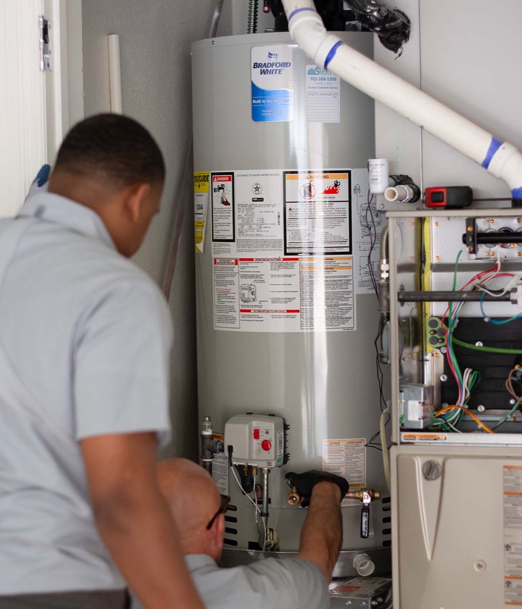 Two Sunrise techs installing a heater tank