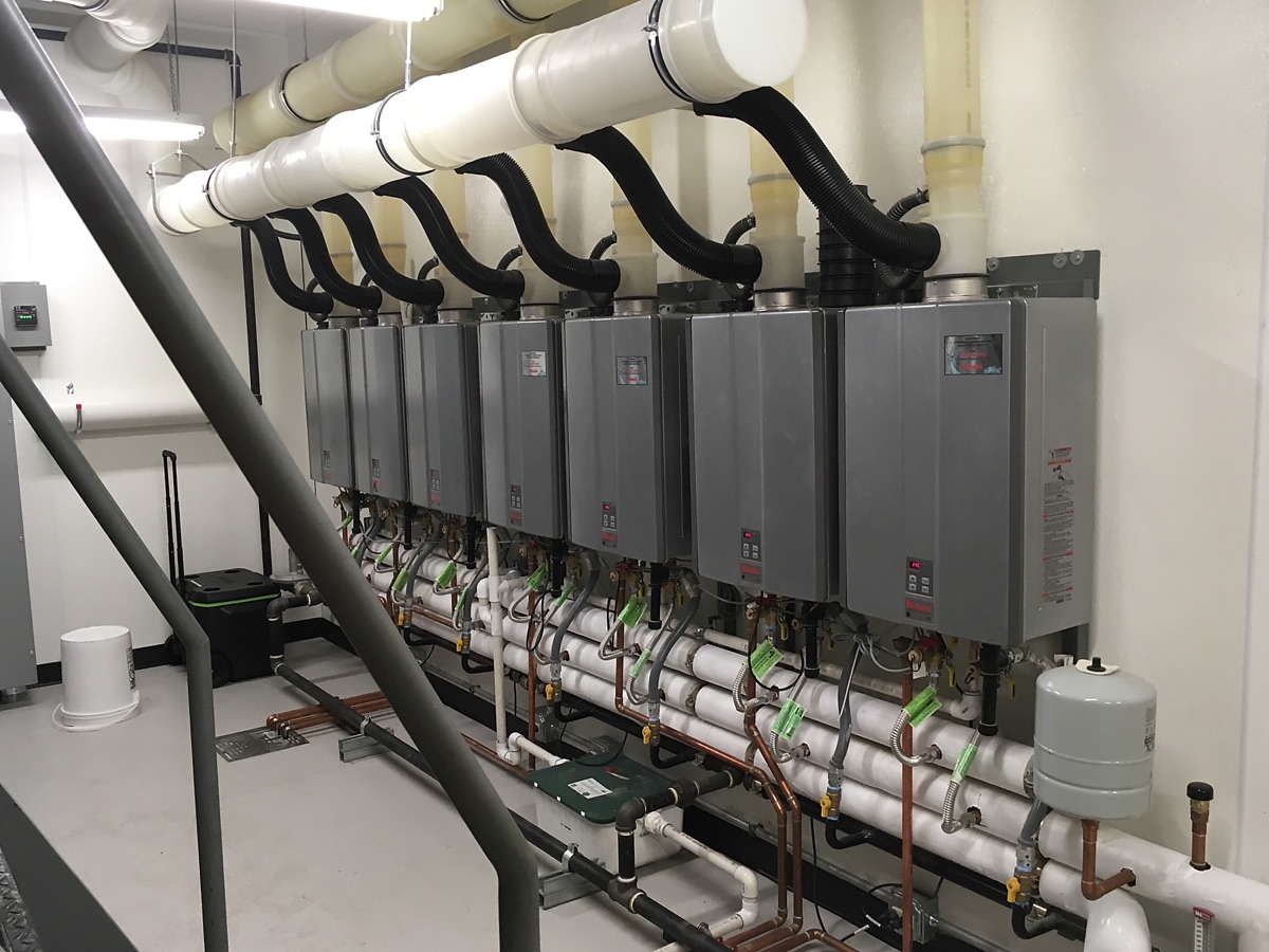 Bank of racked tankless water heaters with common venting (commercial-scale install)