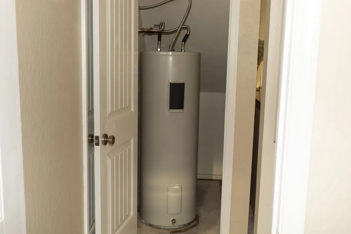 Electric tank water heater installed in a closet