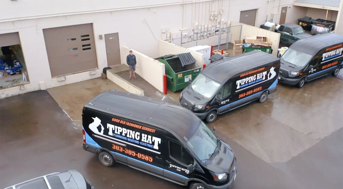 Fleet of Tipping Hat branded service vans at the shop