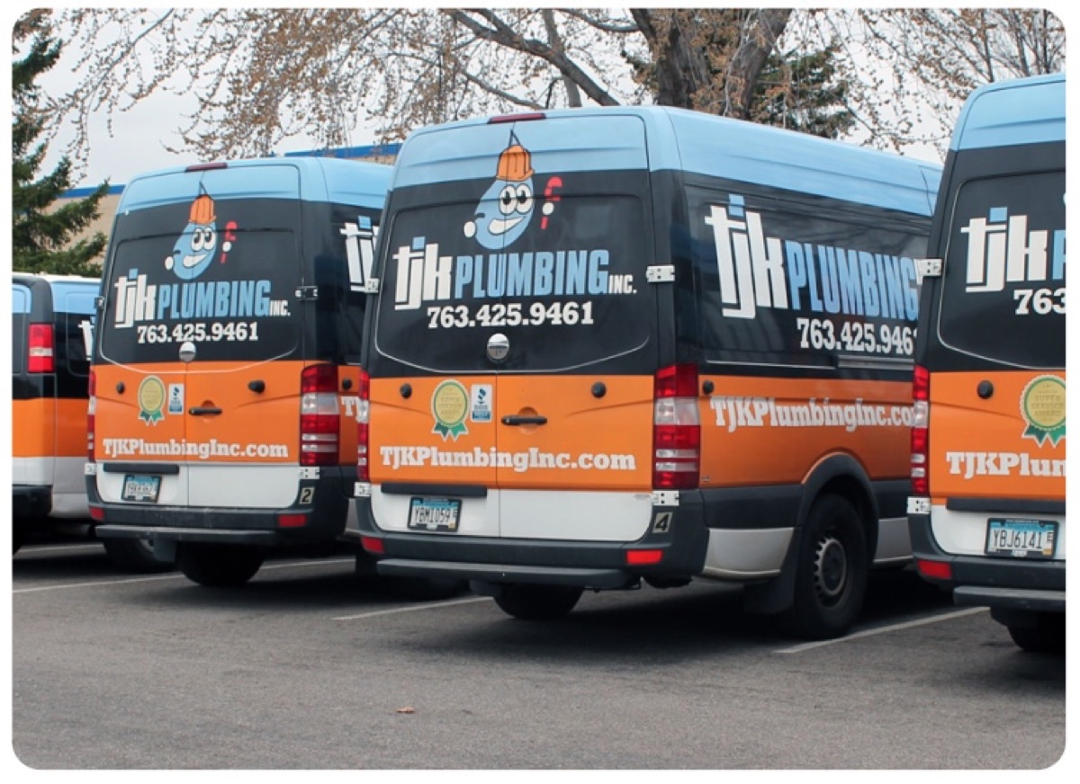 Fleet of orange-and-blue TJK Plumbing vans