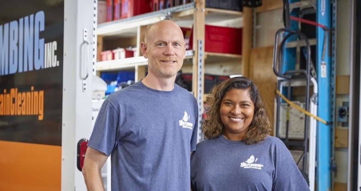 TJK Plumbing owners in branded shirts in the company shop