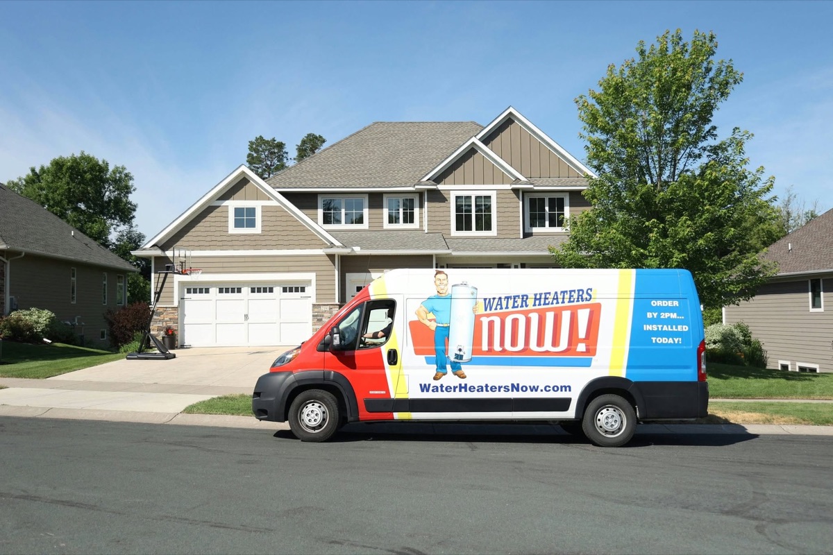 Water Heaters Now branded van parked in a suburban driveway