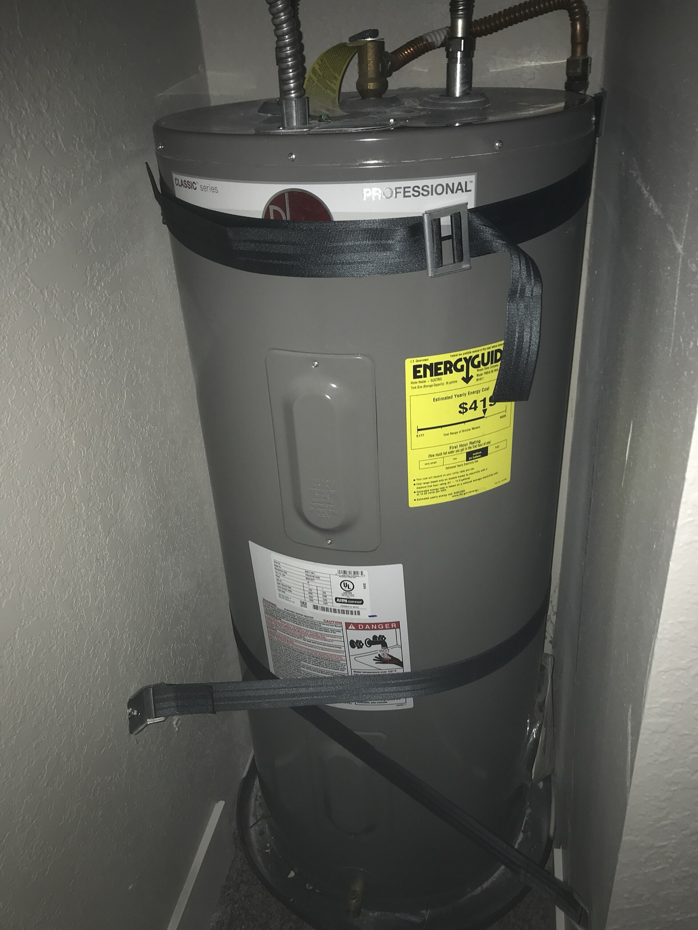 Gray 40-gallon electric tank water heater with yellow EnergyGuide label
