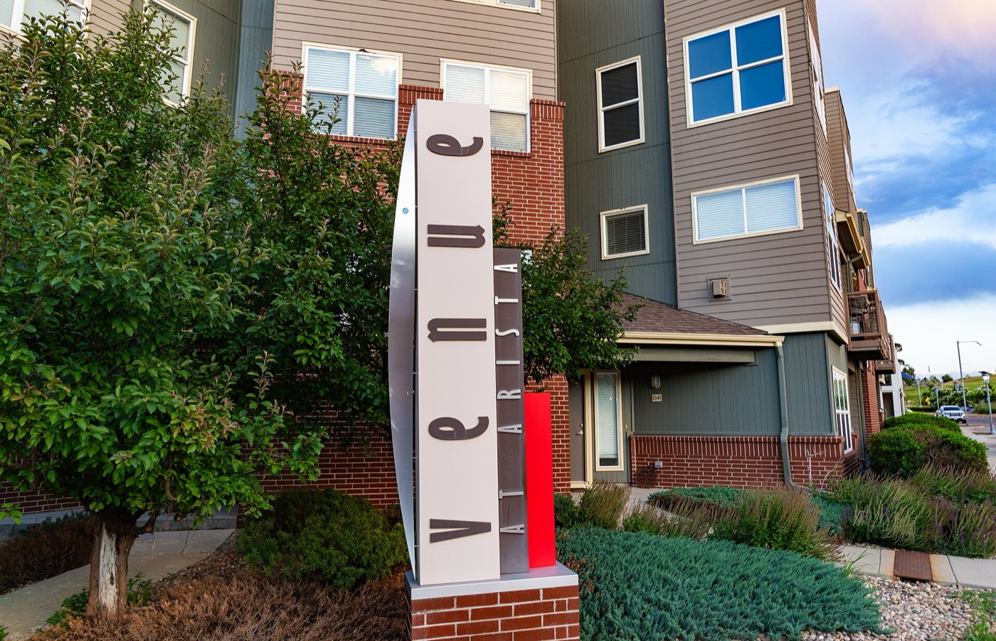 Modern multi-story townhomes with landscaping near Arista Place in Broomfield