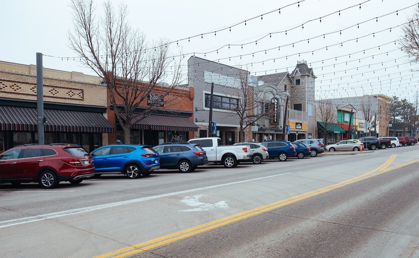 Downtown Castle Rock storefronts along Wilcox Street with string lights overhead
