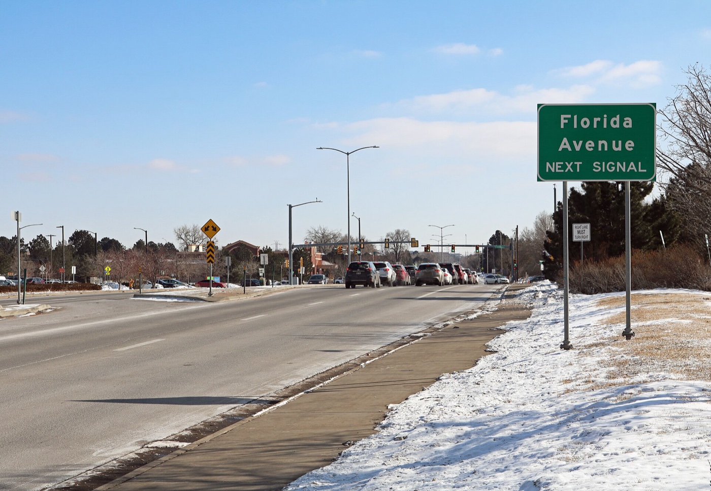 Parker Road running south through the Four Square Mile area with trees and light snow
