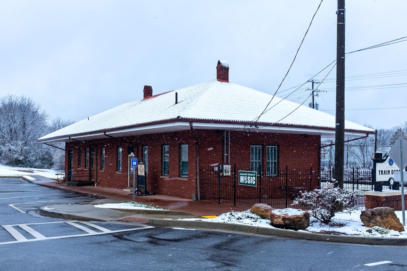 The historic Lawrenceville train depot in snow beside the CSX main line