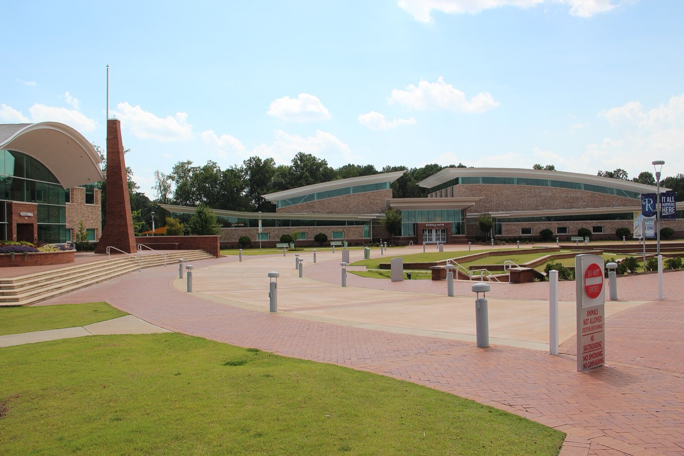 Brick plaza and curved-roof civic buildings at Riverdale Town Center