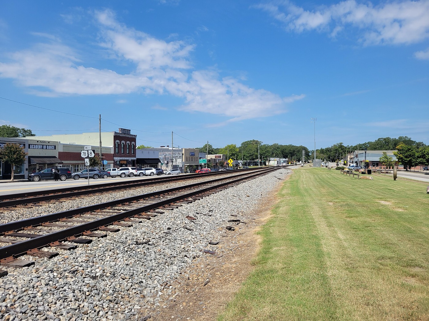 Railroad tracks and a grassy park strip beside downtown Villa Rica, Georgia