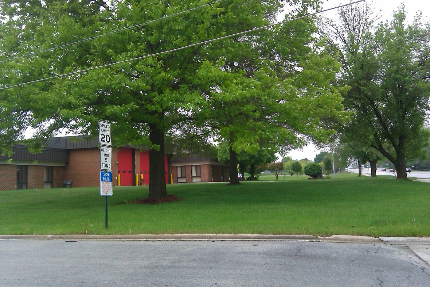 Hazel Crest fire station behind a tree-shaded lawn