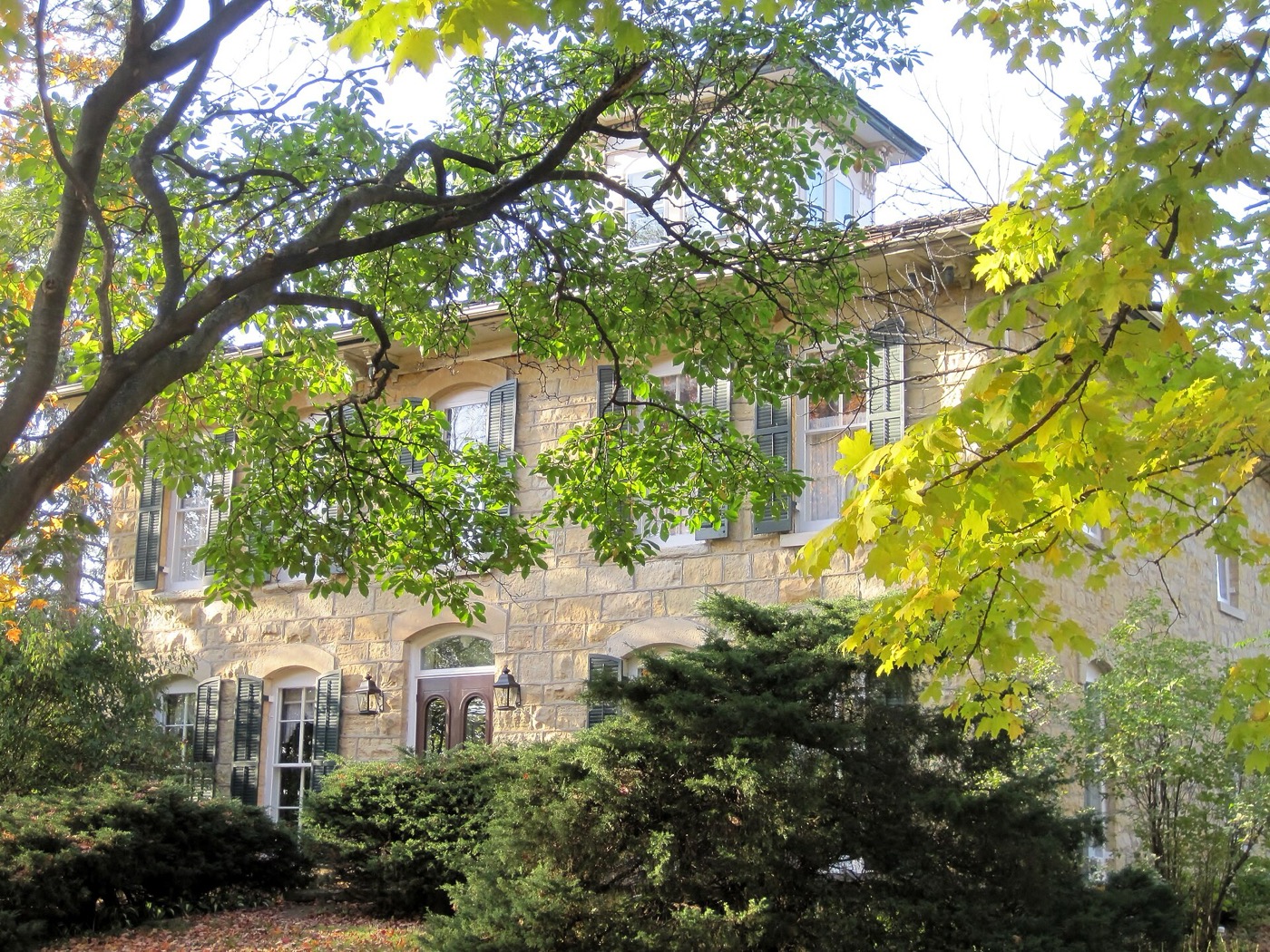 Historic stone house framed by autumn trees in Homer Glen, Illinois