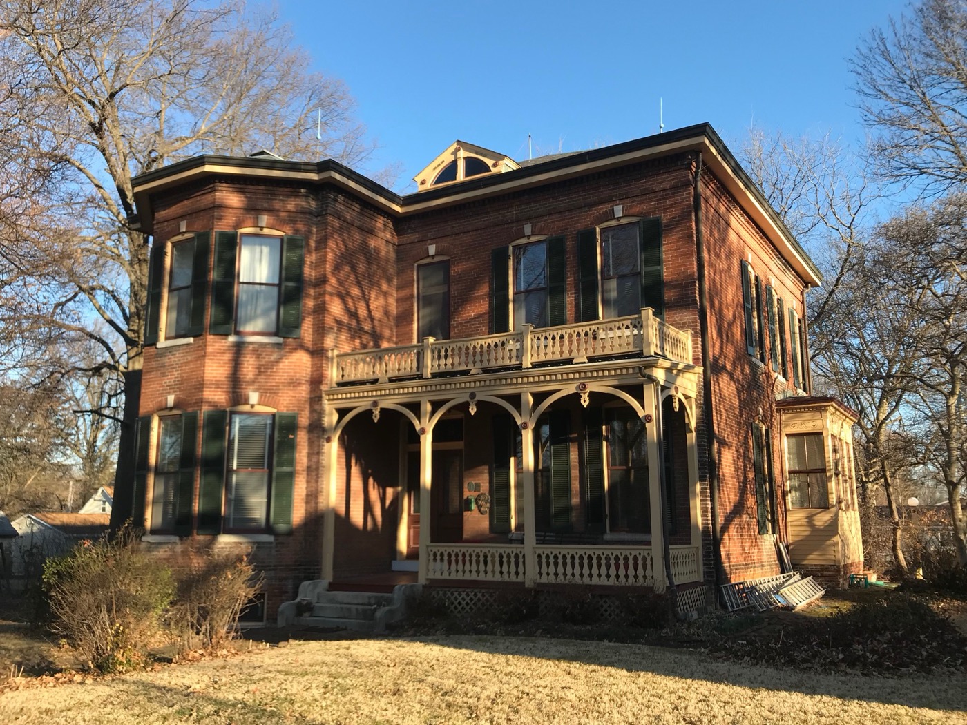 Two-story Italianate brick house with a porch on W. Washington Street in O'Fallon, Illinois