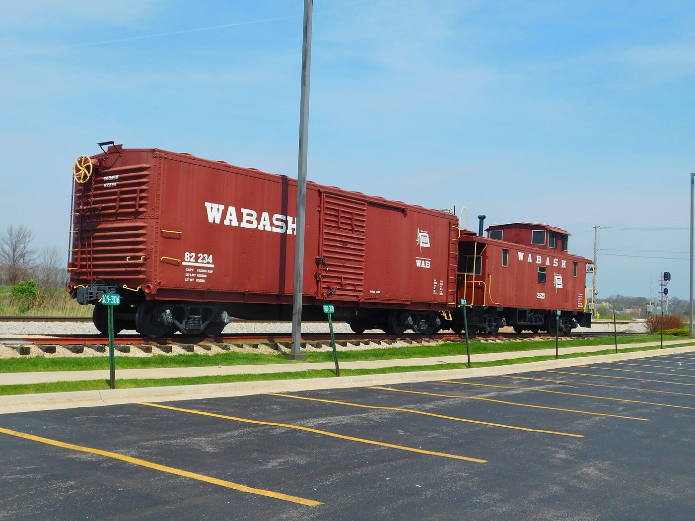 Restored Wabash boxcar and caboose displayed beside the Orland Park station parking lot