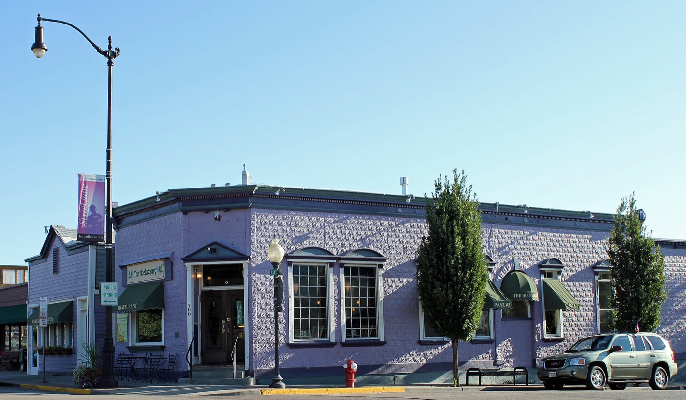 Historic purple Tego Brothers Drugstore building on a corner of Main Street in old-town Louisville