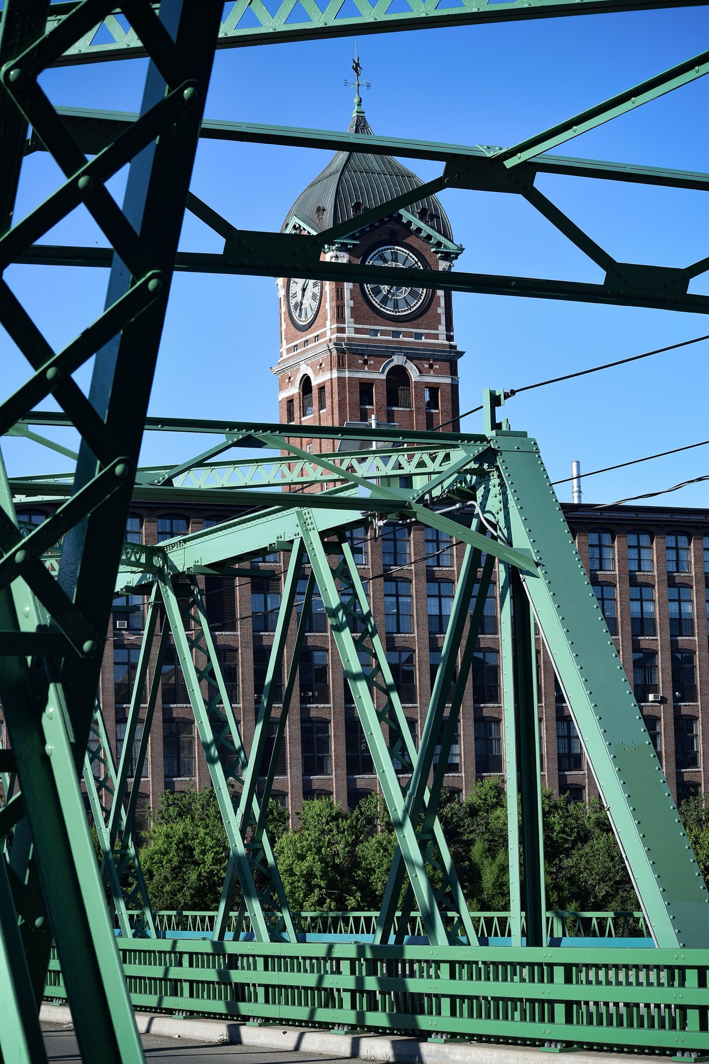 The Duck Bridge over the Merrimack River with the Ayer Mill clock tower behind it in Lawrence