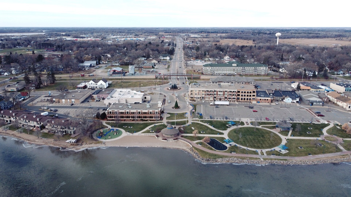 Aerial view of downtown Forest Lake with the lakefront park, roundabout and water tower