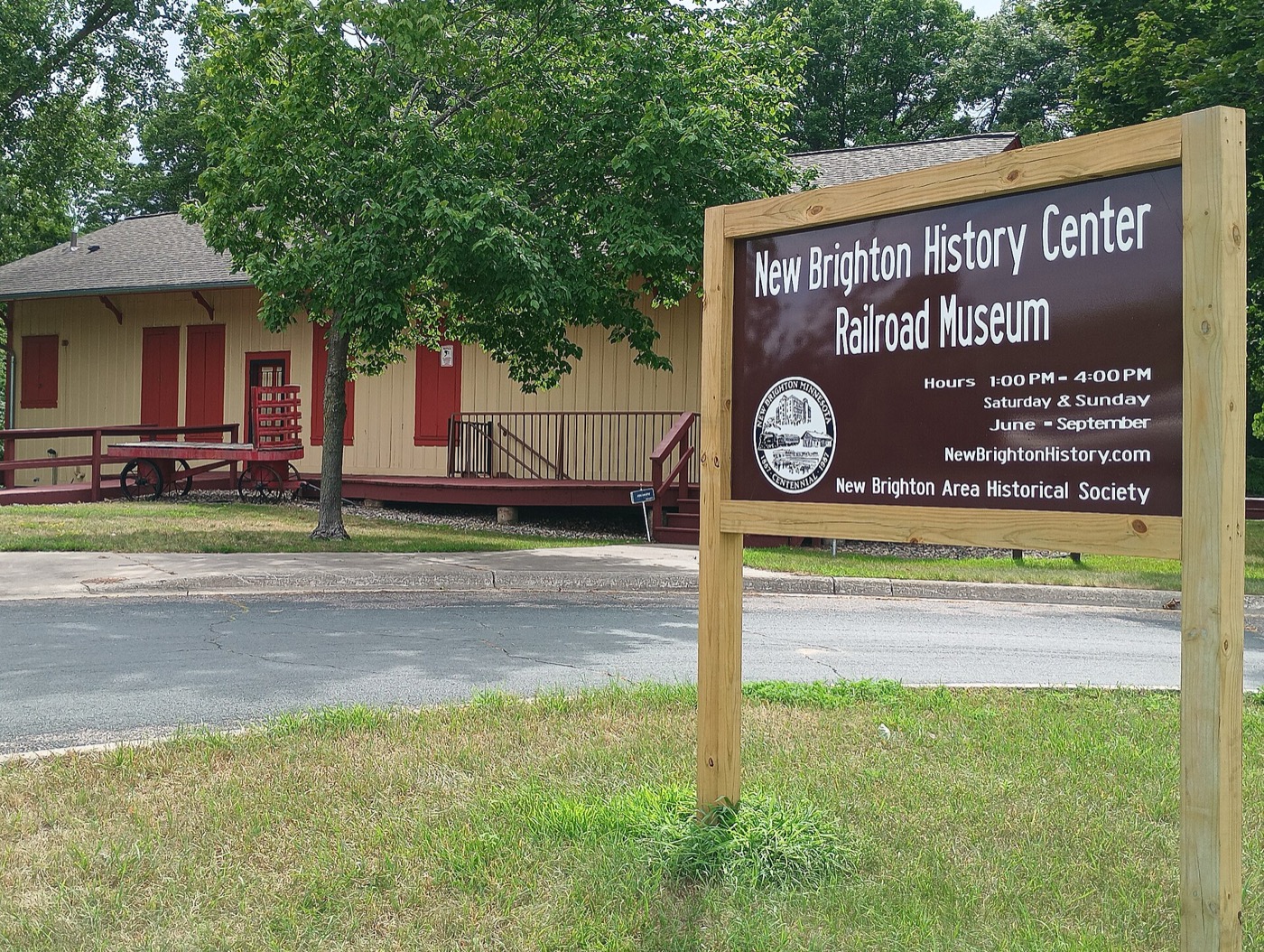 Historic railroad depot and sign for the New Brighton History Center at Long Lake Regional Park