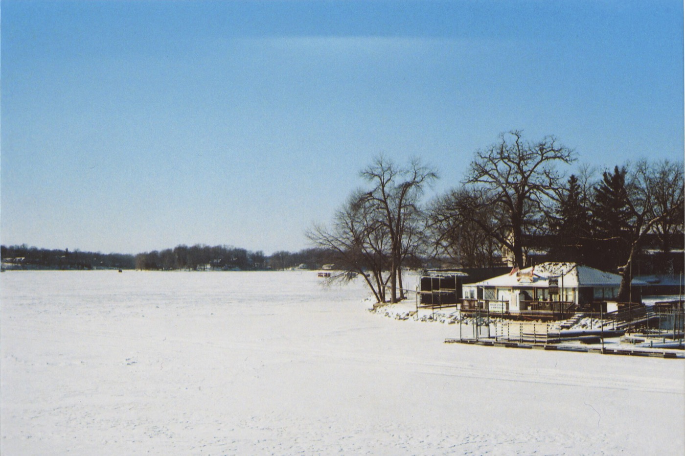 View from a bridge across Prior Lake with open water and wooded shoreline